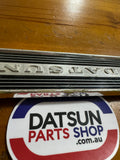 Datsun 410, 411 Radio Blank Plate Badge Used